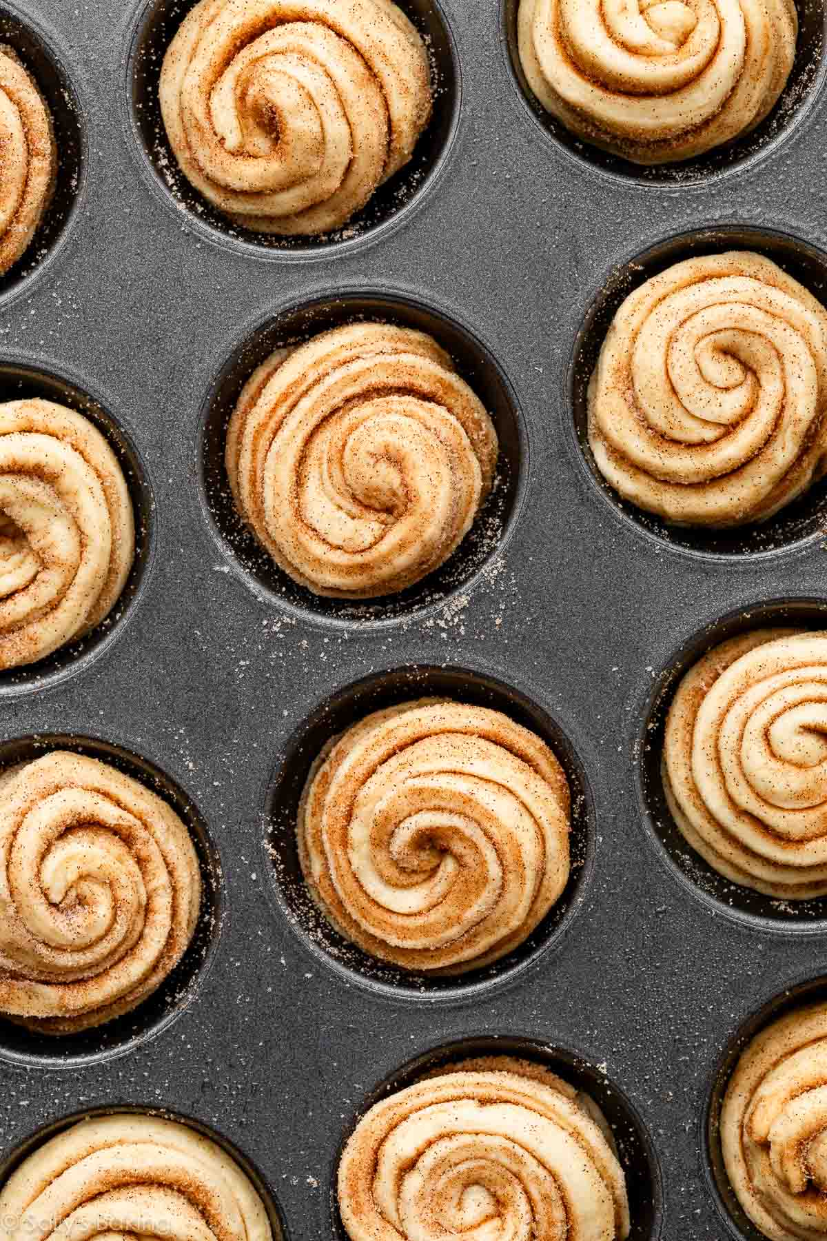 overhead image of cruffins in muffifn pan before baking.