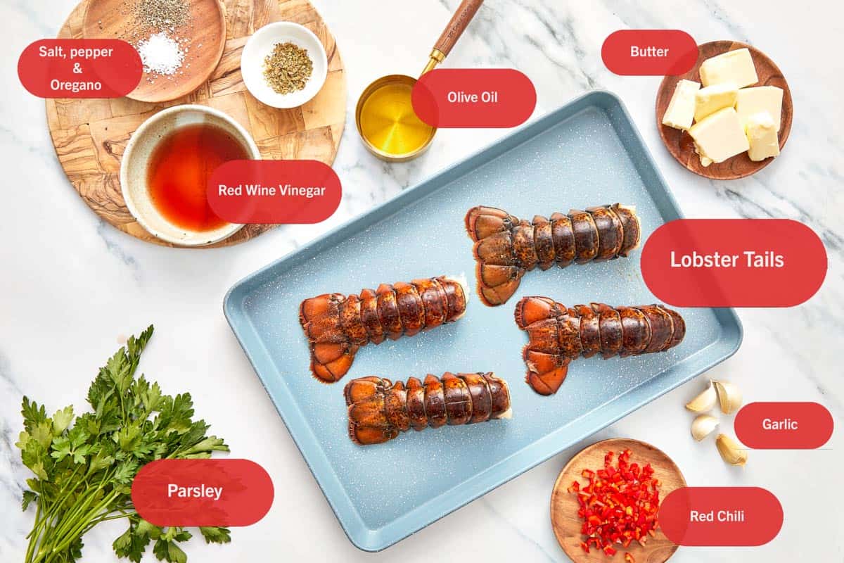 Ingrédients pour les Queues de Homard au Chimichurri étalés sur une surface blanche.